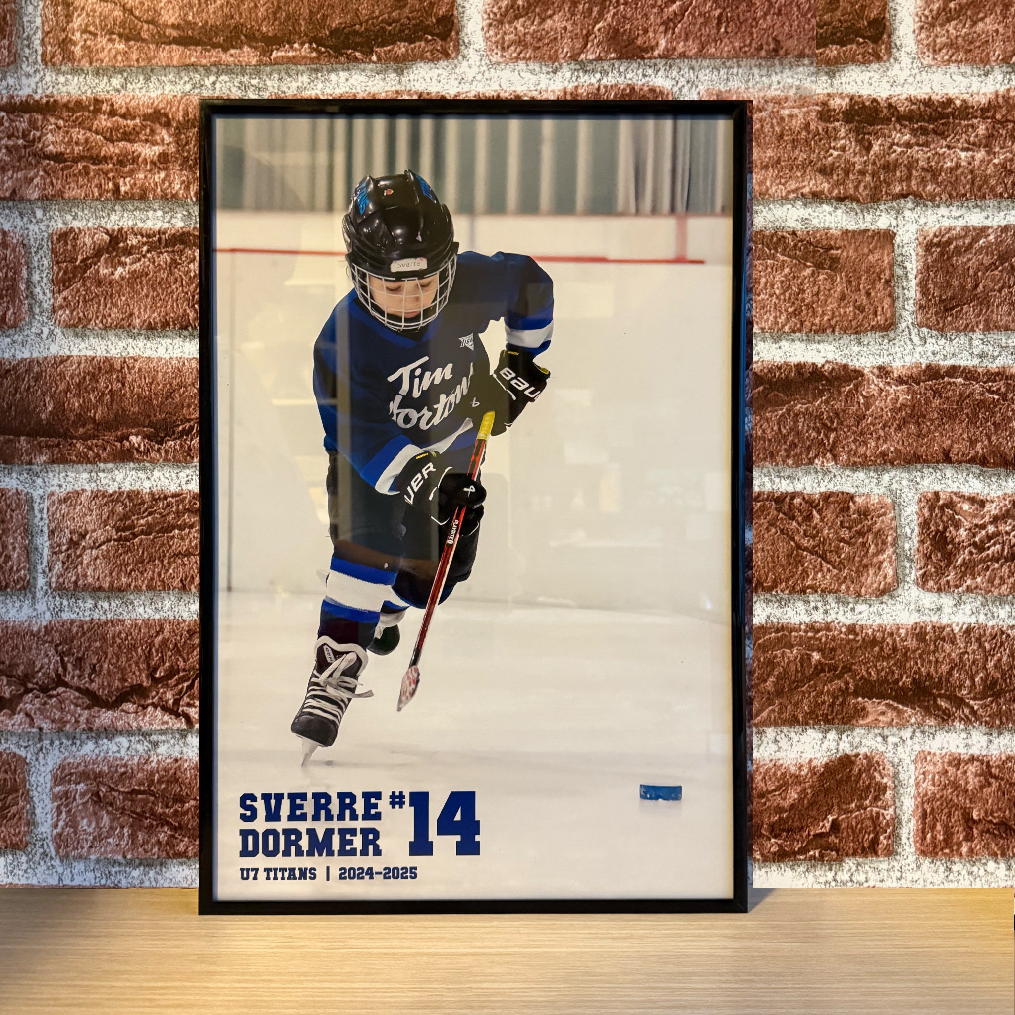 Personalized hockey poster showing child's name, jersey number, team and year inset on an action shot of the child, perfect for kids room or team gift.